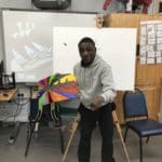 Student displaying his artwork
