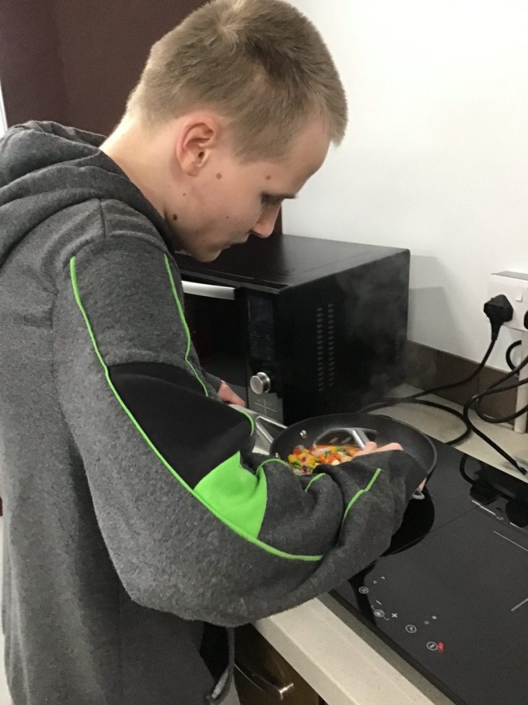 Student cooking on a stove.