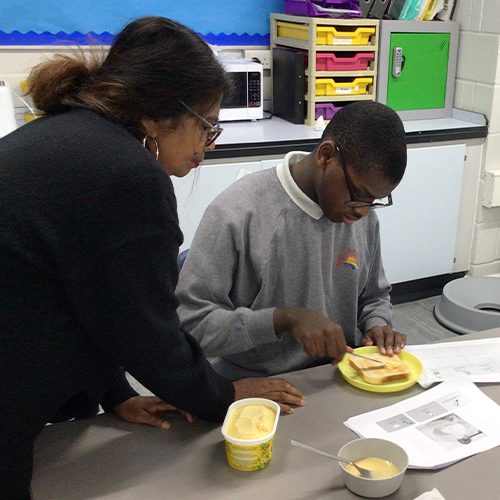 Buttering toast in a cooking lesson