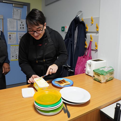 Buttering toast during a cooking lesson