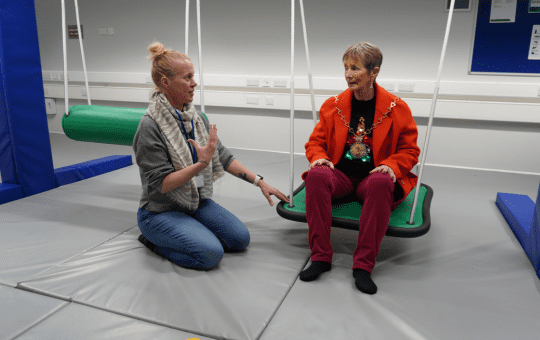 Occupational Therapist Kirsty Richards showing Councillor Linda Bird one of the therapeutic swings