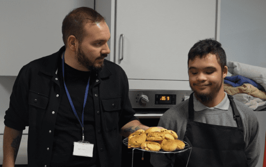 Student in Falconwood class learning to bake cookies with his teacher Student in Falconwood class learning to bake cookies with his teacher