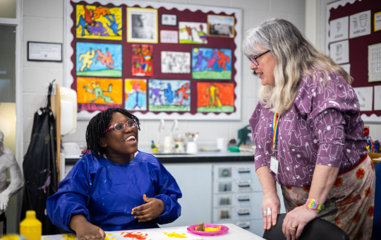 Charlton Park Academy student in art class with the art teacher Charlton Park Academy student in art class with the art teacher